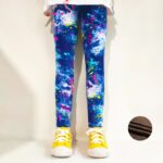 Girl wearing blue graffiti splash fleece leggings with colourful pink, yellow, turquoise and white paint effect print.
