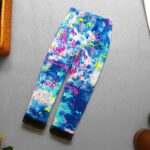 Full length graffiti splash fleece leggings for girls in blue with bright pink, yellow, turquoise and white paint effect print.