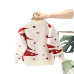Back view of cream kids Christmas jumper with red Christmas tree pattern, snowflakes and ribbed cuffs and hem.