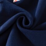 Kids Christmas Reindeer Jumper - navy (4) Close-up of soft navy knitted fabric used for kids Christmas reindeer jumper, showing smooth and flexible material.