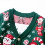 Close up of green Christmas cardigan with Santa Claus and snowman knitted design