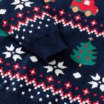 Kids Navy Christmas Truck Jumper (4) Close-up of kids navy Christmas truck jumper showing ribbed sleeve cuff, green Christmas trees, white snowflakes and festive pattern.