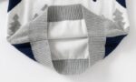 Inside view of kids polar bear Christmas jumper showing soft knitted fabric, grey ribbed hem and neat knitted construction.