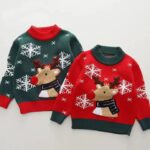 Red and green kids Christmas jumpers with funnel necks, reindeer designs, white snowflakes and contrasting ribbed trims.