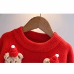 Kids Teddy Bear Christmas Jumper (3) Close-up of red kids Christmas jumper showing the soft knitted fabric, ribbed crew neck and teddy bear appliqués.