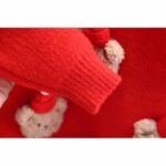 Kids Teddy Bear Christmas Jumper (6) Close-up of red kids Christmas jumper sleeve showing the soft knitted finish and ribbed cuff detail.