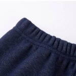 Close-up of denim navy girls fleece leggings showing the elasticated waistband and textured fabric