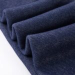 Close-up of denim navy girls fleece leggings showing the soft textured outer fabric